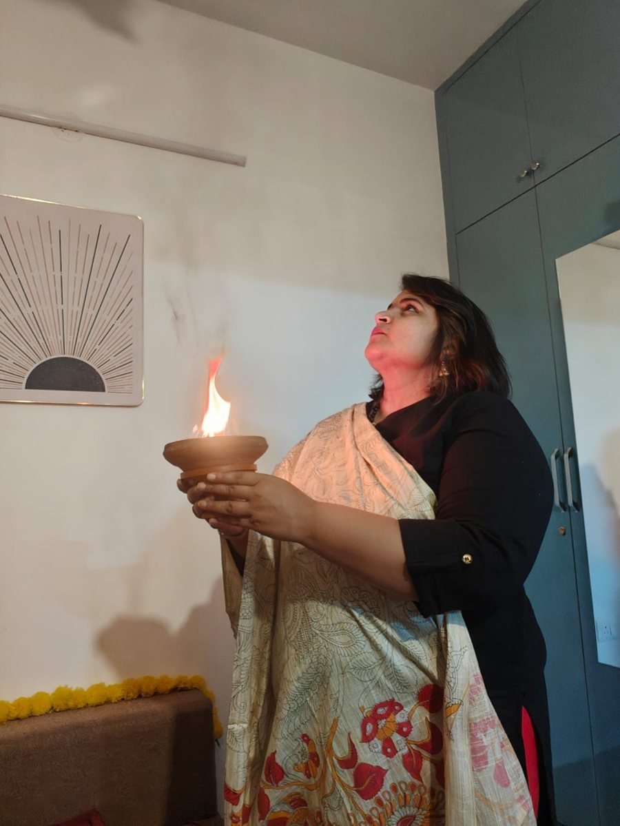 Neha Singla offering a diya